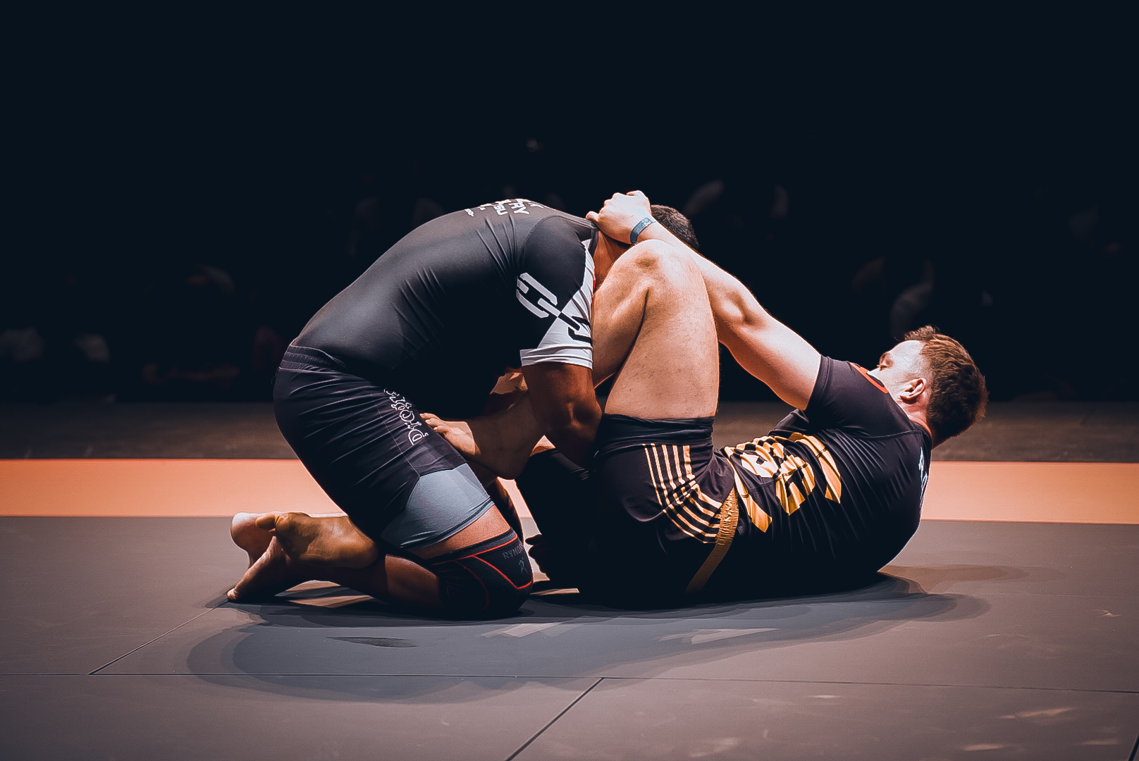 Guard player breaking posture on stage at GrappleMax