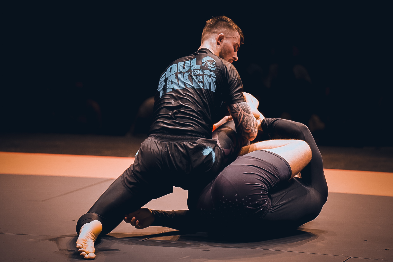Soul Taker competitor working from top half guard